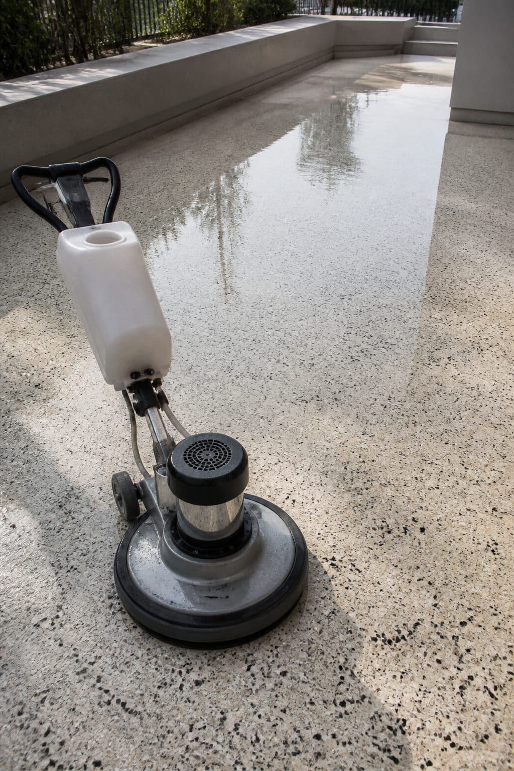 Terrazzo floor during polishing with industrial equipment on an outdoor terrace