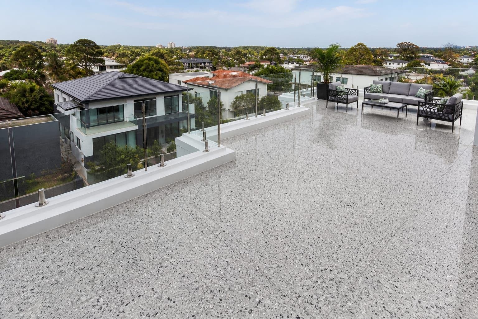 High-gloss polished terrazzo flooring on a modern outdoor residential rooftop terrace