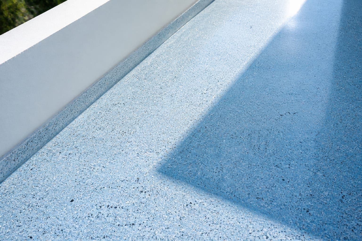 Polished light blue terrazzo surface with architectural detailing